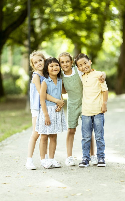 Group of asian and caucasian kids having fun in the park